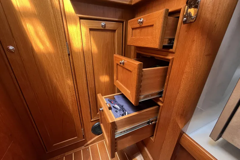 Slide: The Image of Wooden cabinetry with open drawers inside a 2017 Rustler 37 yacht interior. - 50