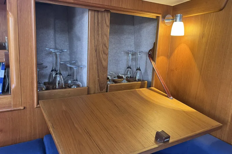 Slide: The Image of Wooden interior of 2017 Rustler 37 yacht with glassware and ambient lighting. - 55