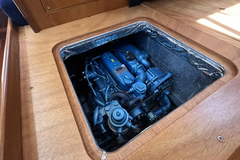 Slide: The Image of Engine compartment of a 2017 Rustler 37 sailboat, showcasing detailed mechanical components. - 56