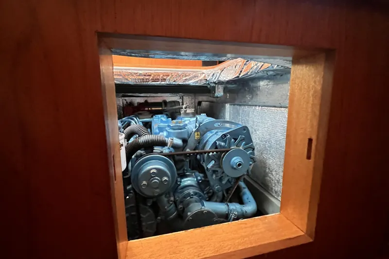 Slide: The Image of Engine compartment of a 2017 Rustler 37 sailboat, showcasing mechanical components. - 57