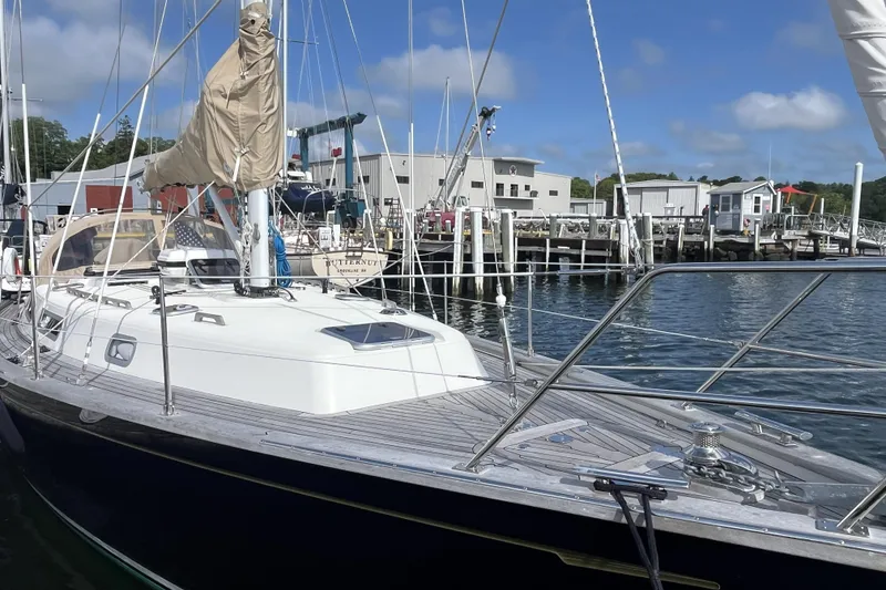 Slide: The Image of Sailboat docked at marina, Rustler 37 model, 2017, with clear blue sky. - 6