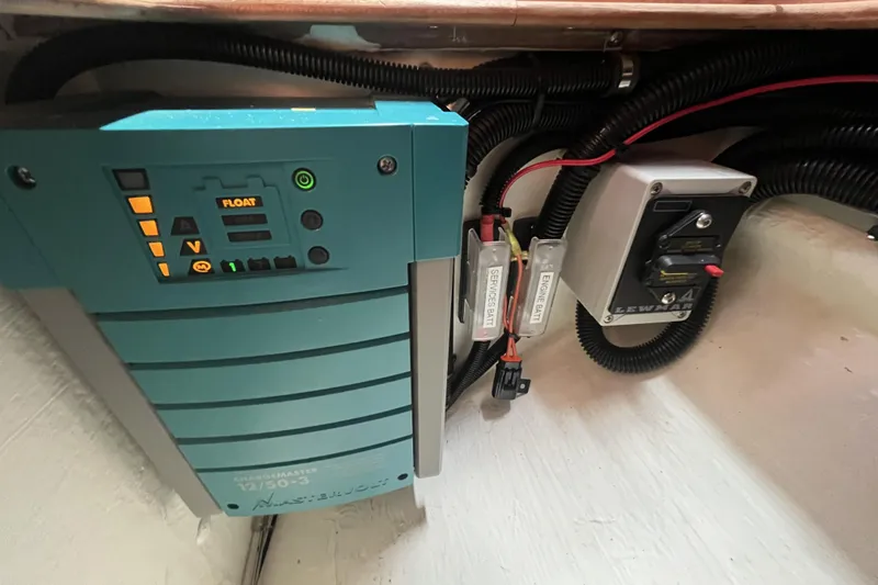 Slide: The Image of Electrical system components in a 2017 Rustler 37 yacht, featuring a charger and wiring. - 60