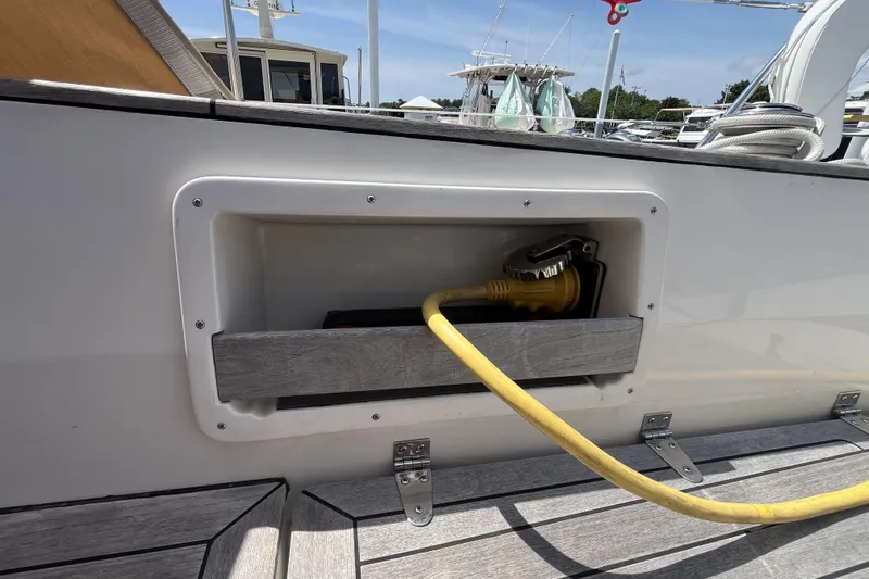 Slide: The Image of Yellow power cable in a 2017 Rustler 37 sailboat's deck compartment. - 62