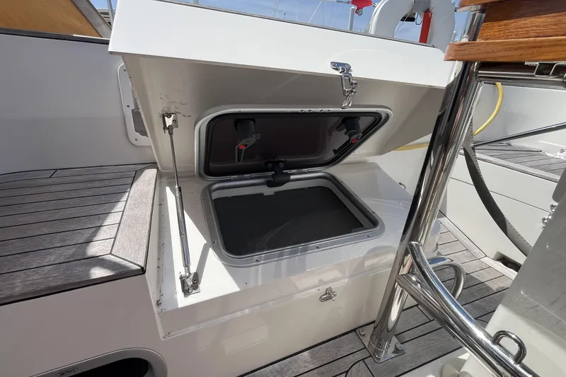 Slide: The Image of Open storage compartment on 2017 Rustler 37 yacht deck, featuring sleek design and stainless steel fittings. - 64