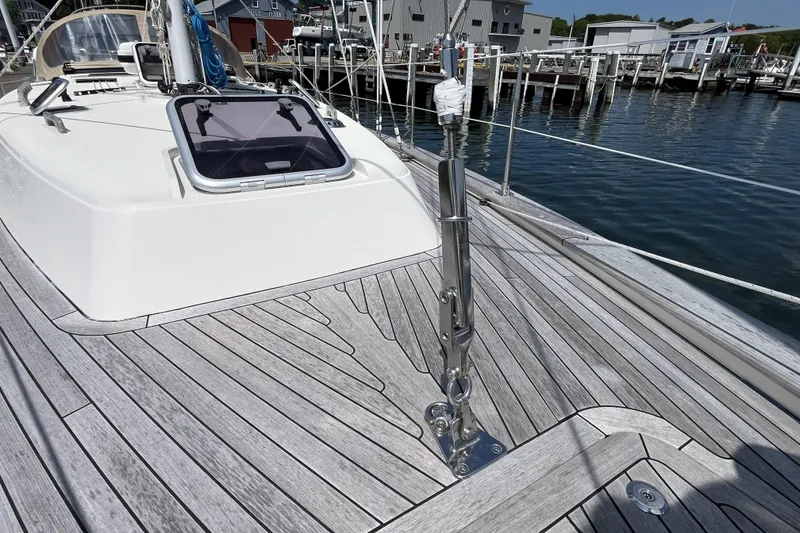Slide: The Image of Deck of 2017 Rustler 37 yacht with sleek wood finish and marina backdrop. - 68