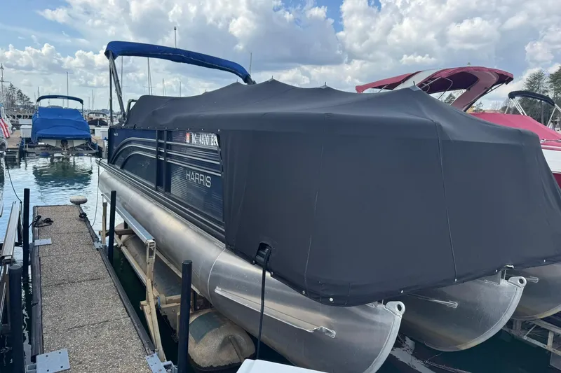 The Image of 2017 Harris FloteBote 240 Sunliner pontoon boat covered at marina dock. - 1