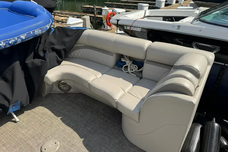 Slide: The Image of 2017 Harris FloteBote 240 Sunliner with beige seating and blue cover at a dock. - 12