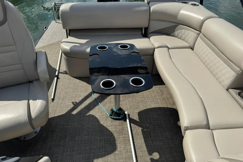 Slide: The Image of 2017 Harris FloteBote 240 Sunliner interior with beige seating and black table. - 15