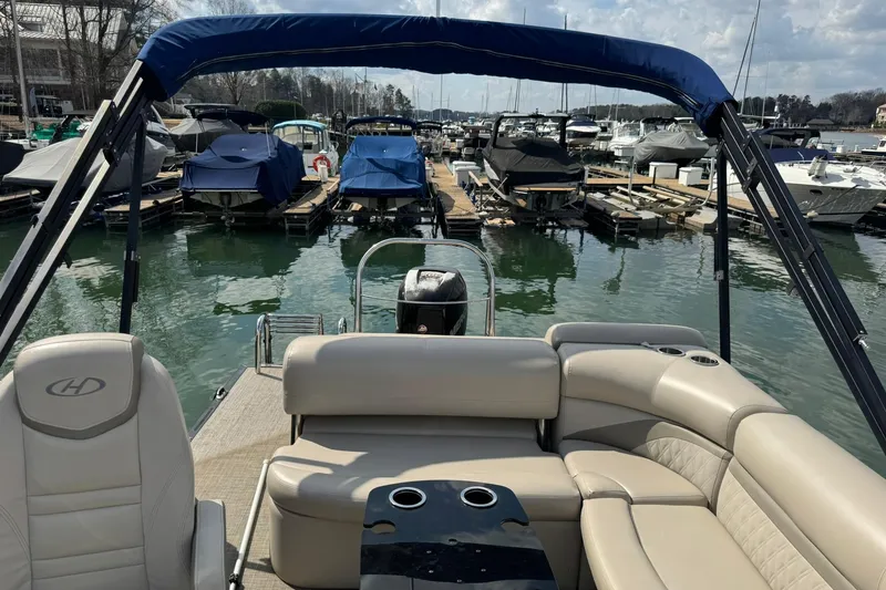 Slide: The Image of 2017 Harris FloteBote 240 Sunliner pontoon boat docked at marina with covered boats. - 16