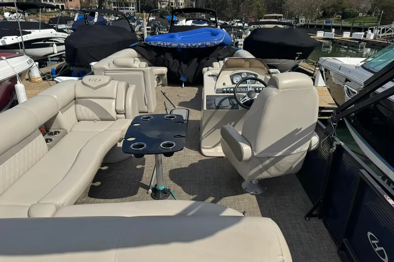 Slide: The Image of 2017 Harris FloteBote 240 Sunliner pontoon boat interior with beige seating and steering console. - 17