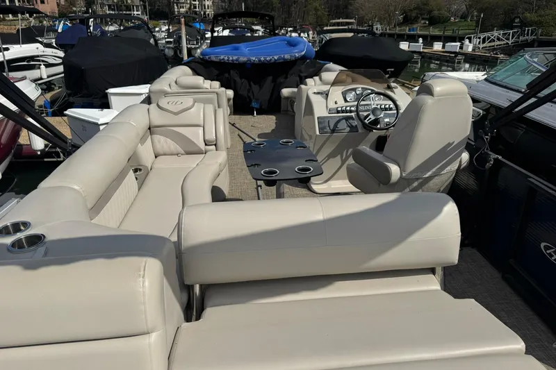 Slide: The Image of 2017 Harris FloteBote 240 Sunliner pontoon boat with beige seating and steering console. - 19