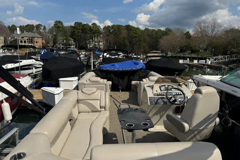 Slide: The Image of 2017 Harris FloteBote 240 Sunliner pontoon boat docked at a marina with covered boats. - 20