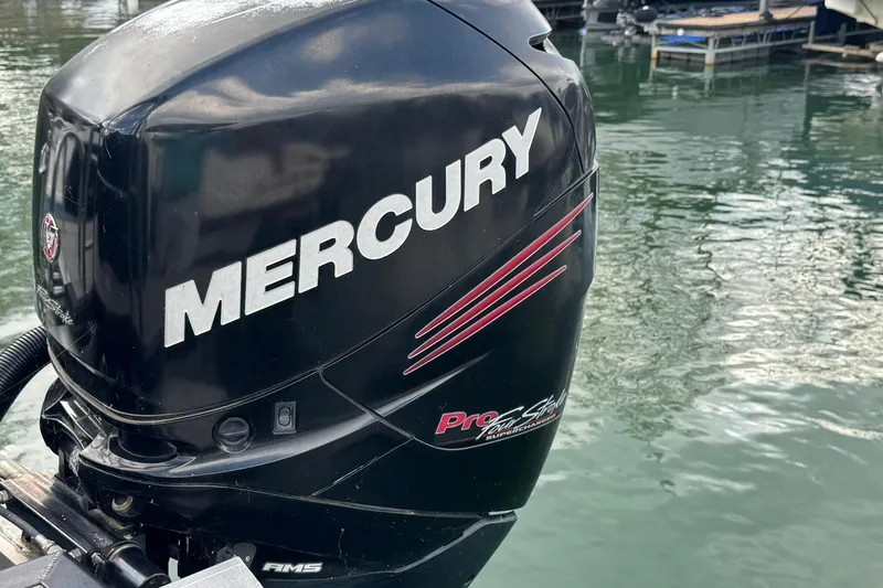 Slide: The Image of Mercury outboard motor on 2017 Harris FloteBote 240 Sunliner, docked by water. - 3