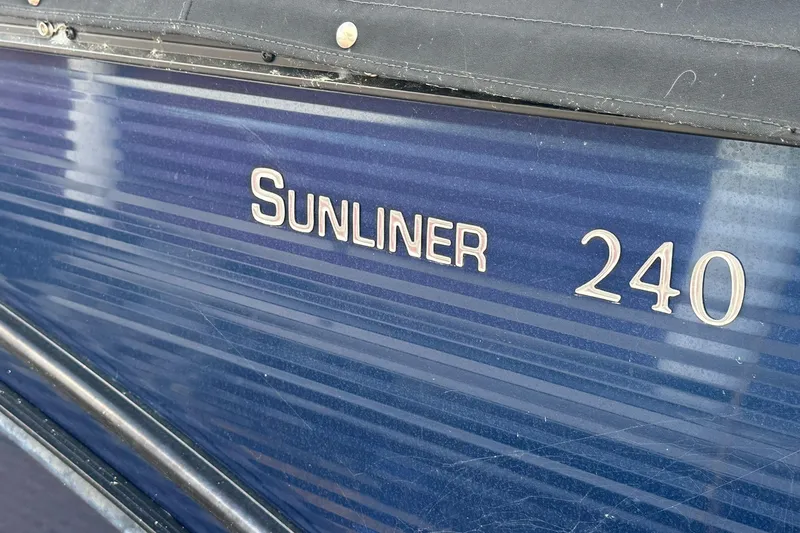 Slide: The Image of 2017 Harris FloteBote 240 Sunliner boat, blue exterior with model name displayed. - 4