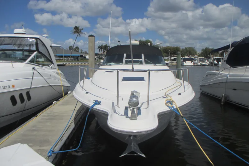 Slide: The Image of 1997 Sea Ray Sundancer 330 docked at marina under blue sky. - 1