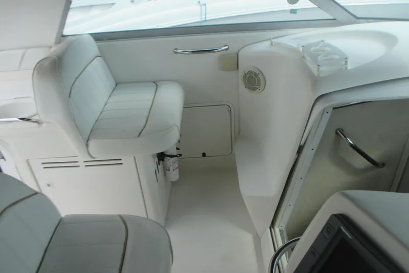 Slide: The Image of 1997 Sea Ray Sundancer 330 interior with white seating and storage compartments. - 10