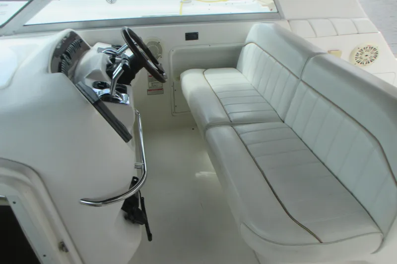 Slide: The Image of 1997 Sea Ray Sundancer 330 helm with white seating and steering wheel. - 12