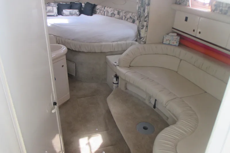 Slide: The Image of Interior of 1997 Sea Ray Sundancer 330 with cozy seating and bed area. - 13