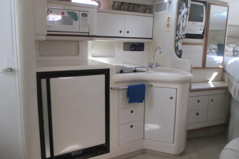 Slide: The Image of Interior of 1997 Sea Ray Sundancer 330 yacht kitchen with appliances and storage. - 14