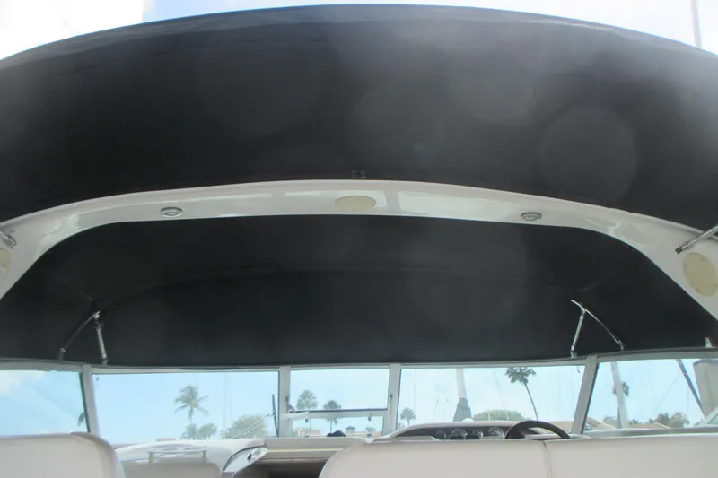 Slide: The Image of 1997 Sea Ray Sundancer 330 boat interior with black canopy and windshield view. - 5