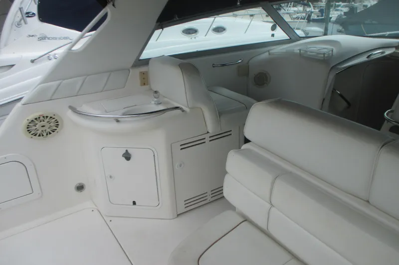 Slide: The Image of Interior of a 1997 Sea Ray Sundancer 330 yacht, featuring white seating and cabinetry. - 8
