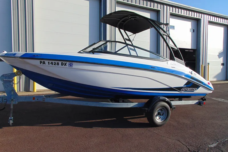 The Image of 2019 Yamaha Boats AR190 on trailer, parked outside industrial building. - 0
