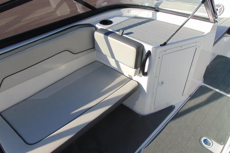Slide: The Image of 2019 Yamaha Boats AR190 interior seating with storage compartment and cup holder. - 10