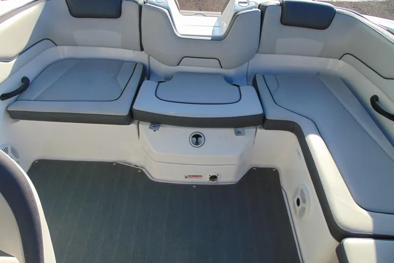 Slide: The Image of 2019 Yamaha Boats AR190 interior seating area with cushioned seats and storage. - 11