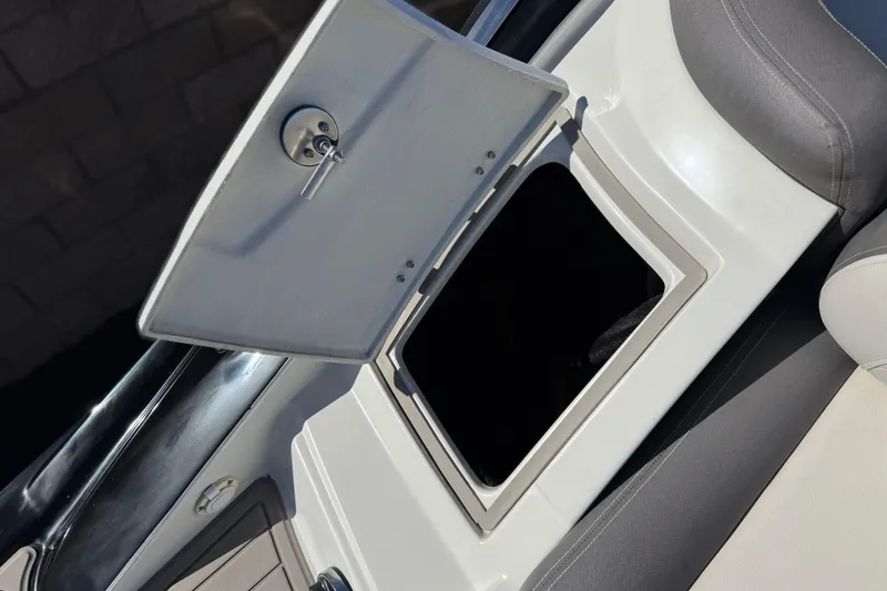 Slide: The Image of Open storage compartment on a 2020 Crownline Eclipse E255 SURF boat. - 12