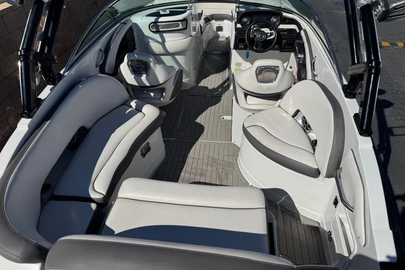 Slide: The Image of 2020 Crownline Eclipse E255 SURF boat interior with sleek seating and modern dashboard. - 13