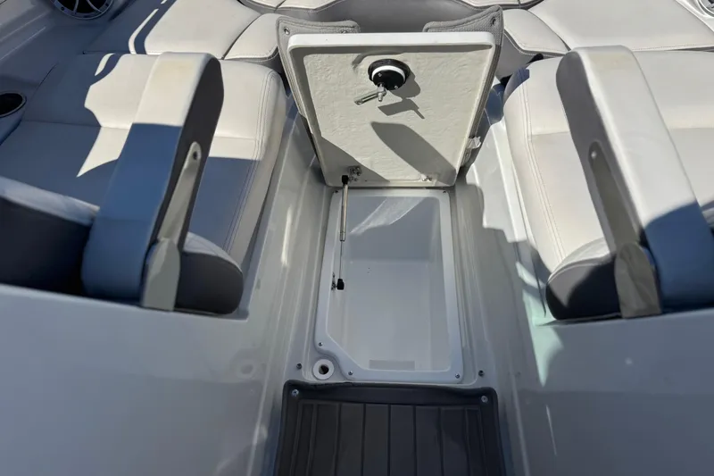 Slide: The Image of 2020 Crownline Eclipse E255 SURF boat interior storage compartment open. - 18