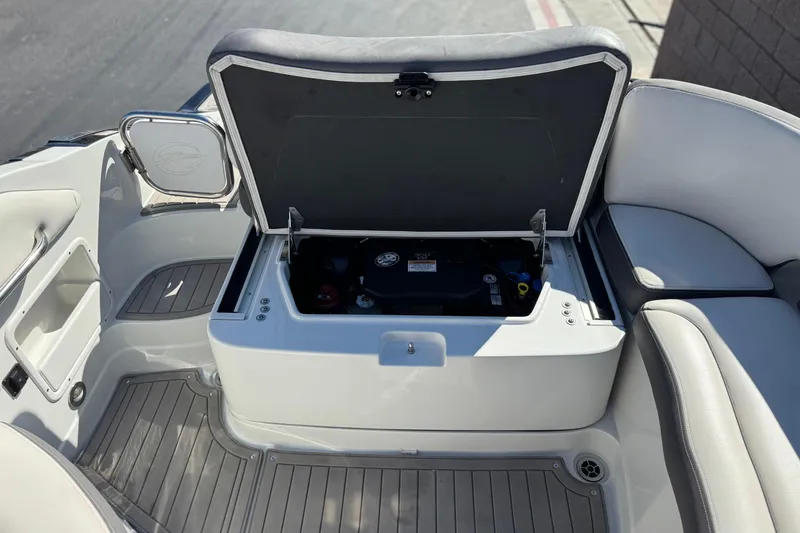 Slide: The Image of 2020 Crownline Eclipse E255 SURF boat with open storage compartment. - 27