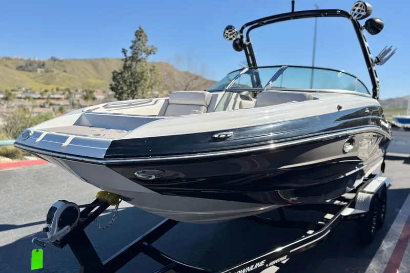 Slide: The Image of 2020 Crownline Eclipse E255 SURF boat on trailer, parked outdoors. - 3