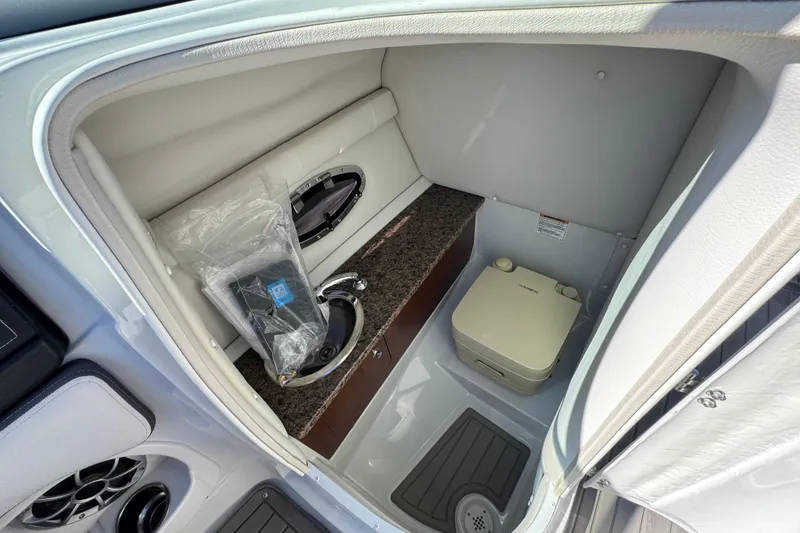 Slide: The Image of 2020 Crownline Eclipse E255 SURF boat interior with sink and portable toilet. - 31