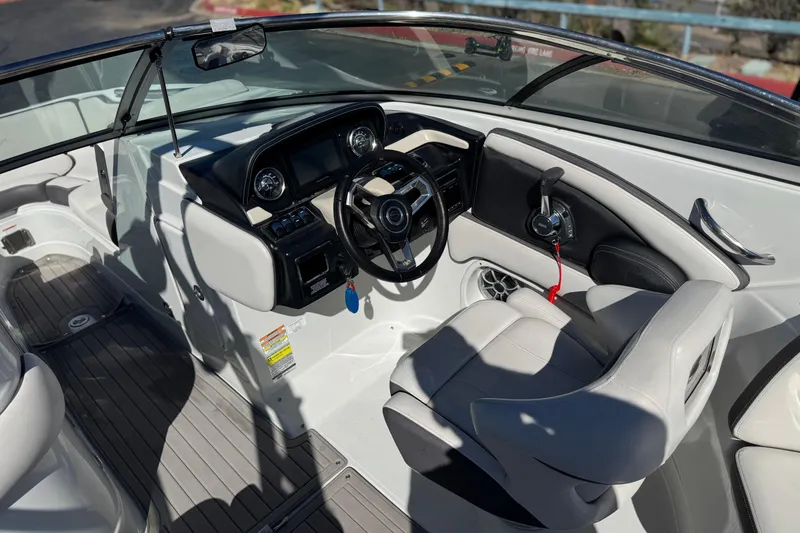 Slide: The Image of 2020 Crownline Eclipse E255 SURF boat interior with steering wheel and seating. - 33