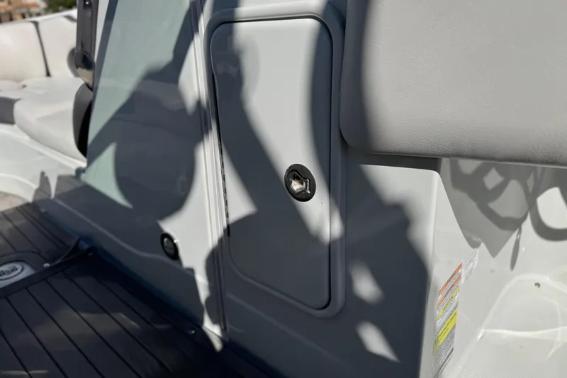 Slide: The Image of 2020 Crownline Eclipse E255 SURF boat interior with storage compartment and seating. - 37