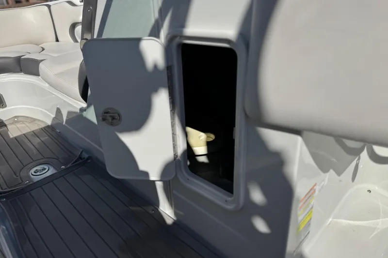 Slide: The Image of 2020 Crownline Eclipse E255 SURF boat interior storage compartment open. - 38