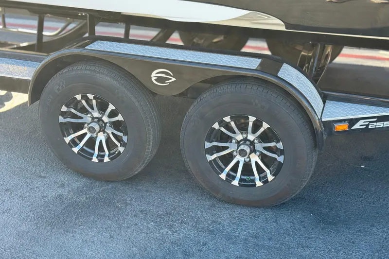 Slide: The Image of Trailer wheels of a 2020 Crownline Eclipse E255 SURF boat on pavement. - 39