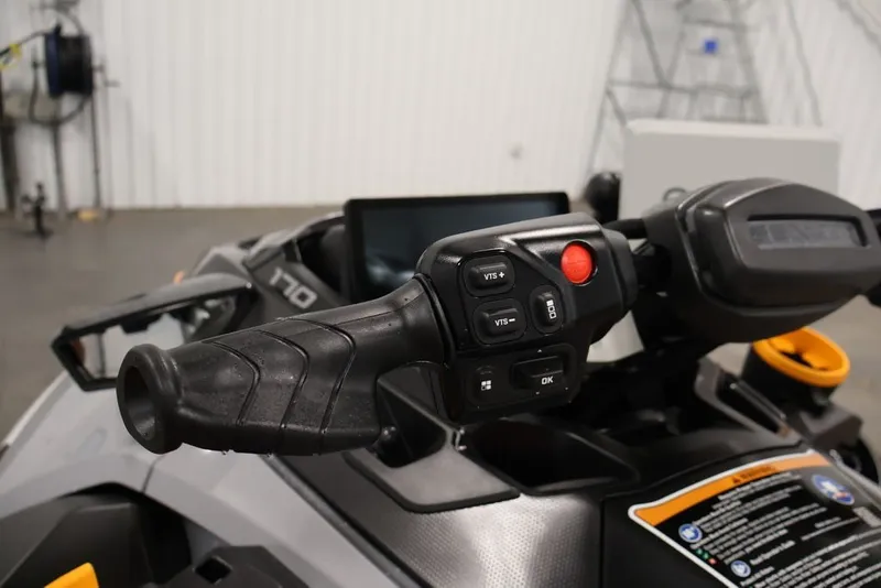 Slide: The Image of 2026 Sea-Doo FishPro Trophy 170 handlebar controls in a garage setting. - 14