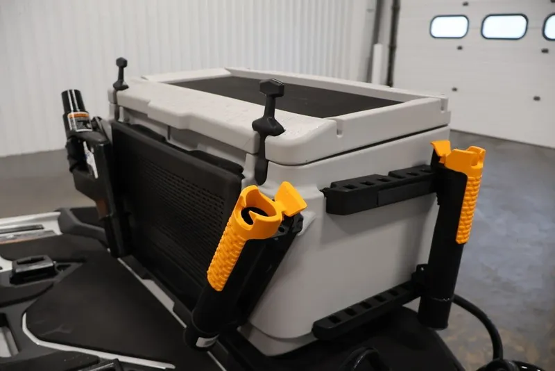 Slide: The Image of 2026 Sea-Doo FishPro Trophy 170 fishing gear storage with rod holders in a garage setting. - 21