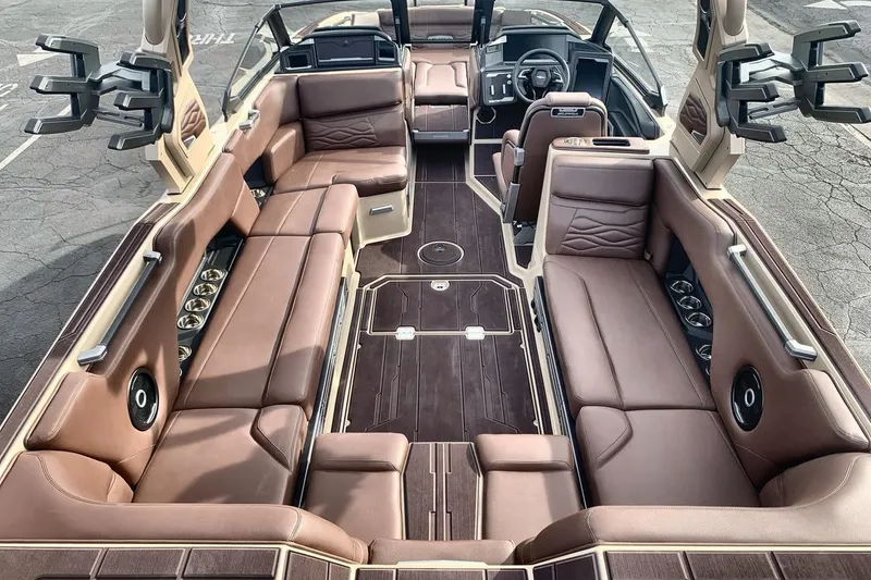 Slide: The Image of Luxurious interior of 2026 Supra SE 550 boat with brown leather seating and modern design. - 10