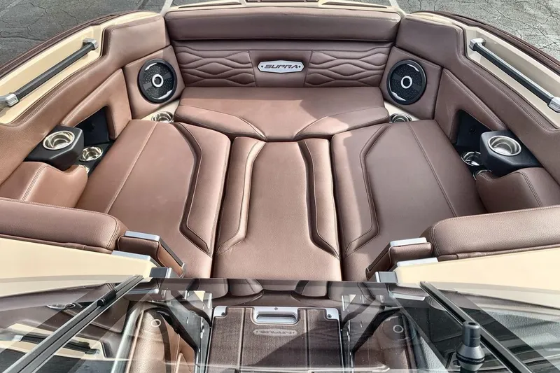 Slide: The Image of Luxurious interior of 2026 Supra SE 550 boat with brown leather seating and speakers. - 11