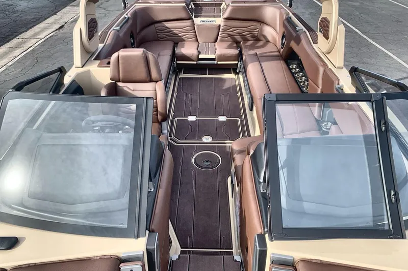 Slide: The Image of 2026 Supra SE 550 boat interior with luxurious brown leather seating and sleek design. - 12
