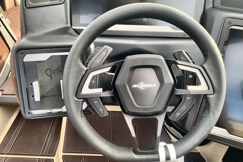 Slide: The Image of Steering wheel of 2026 Supra SE 550 with integrated controls and touchscreen display. - 14
