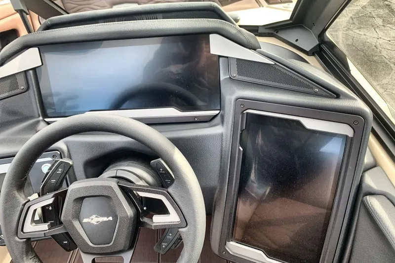 Slide: The Image of 2026 Supra SE 550 dashboard with dual touchscreens and modern steering wheel design. - 16