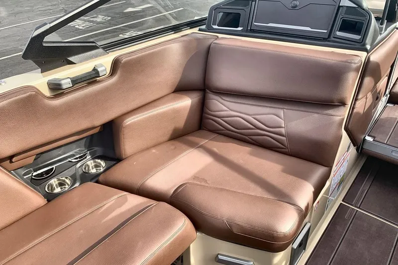 Slide: The Image of Luxurious brown leather seating in 2026 Supra SE 550 boat interior with cup holders. - 17