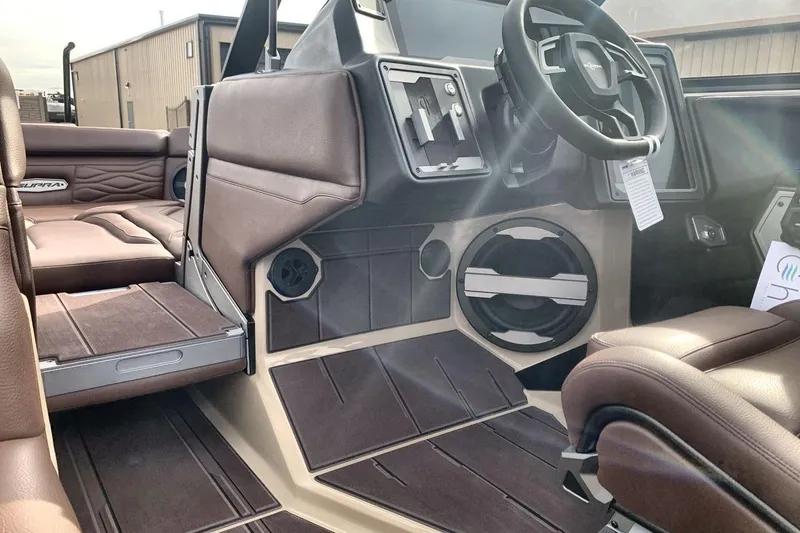 Slide: The Image of 2026 Supra SE 550 interior with brown leather seats and modern dashboard design. - 27