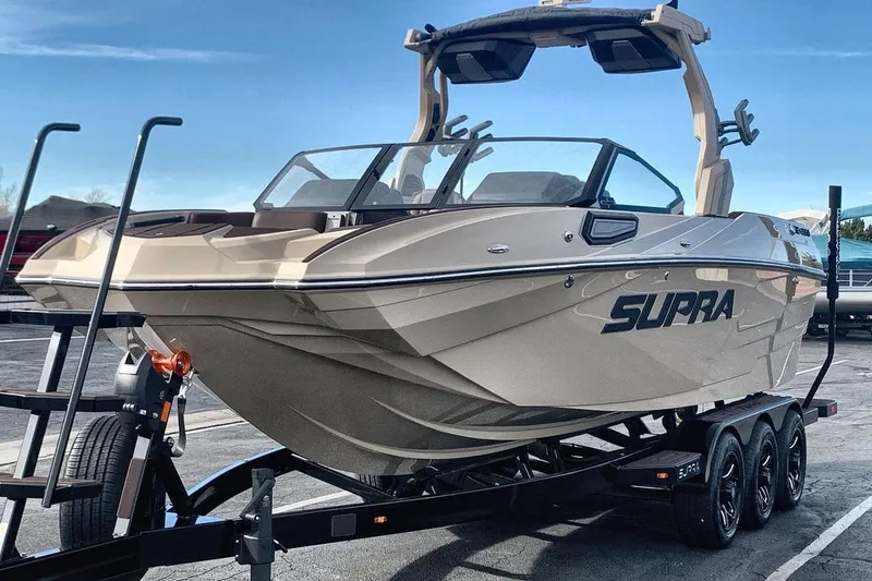 Slide: The Image of 2026 Supra SE 550 boat on trailer, showcasing sleek design and modern features. - 3