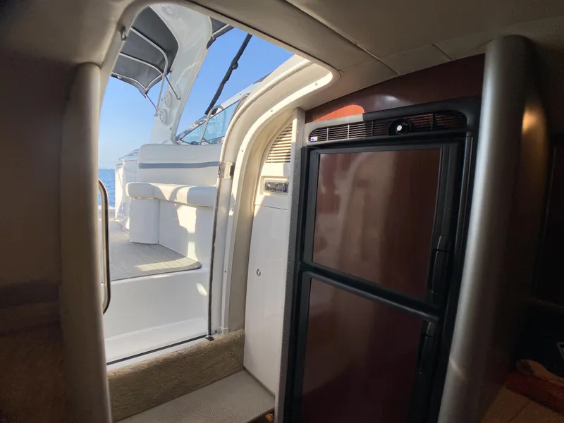 Slide: The Image of Interior view of 2006 Formula 400 Super Sport yacht, featuring a compact kitchen area. - 16