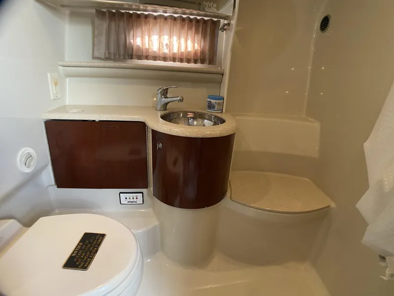 Slide: The Image of 2006 Formula 400 Super Sport bathroom with sink, toilet, and storage cabinet. - 19
